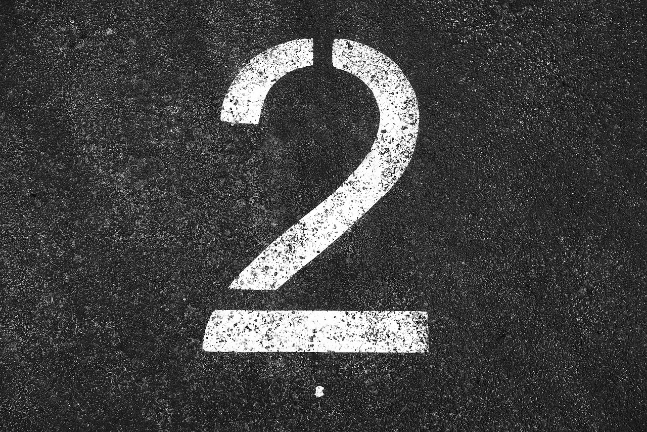 two 2 number two number numeral digit symbol white number two tarmac parking lot parking section indication gray digital gray park gray numbers two two number two number two number two number two number two number tarmac