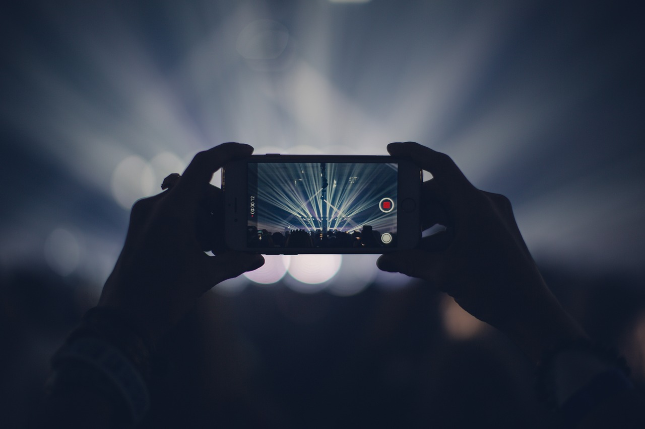 iphone concert lights stage lights record video recording video recording capture apple product hands audience event live event live performance dark party smartphone crowd video video video video video